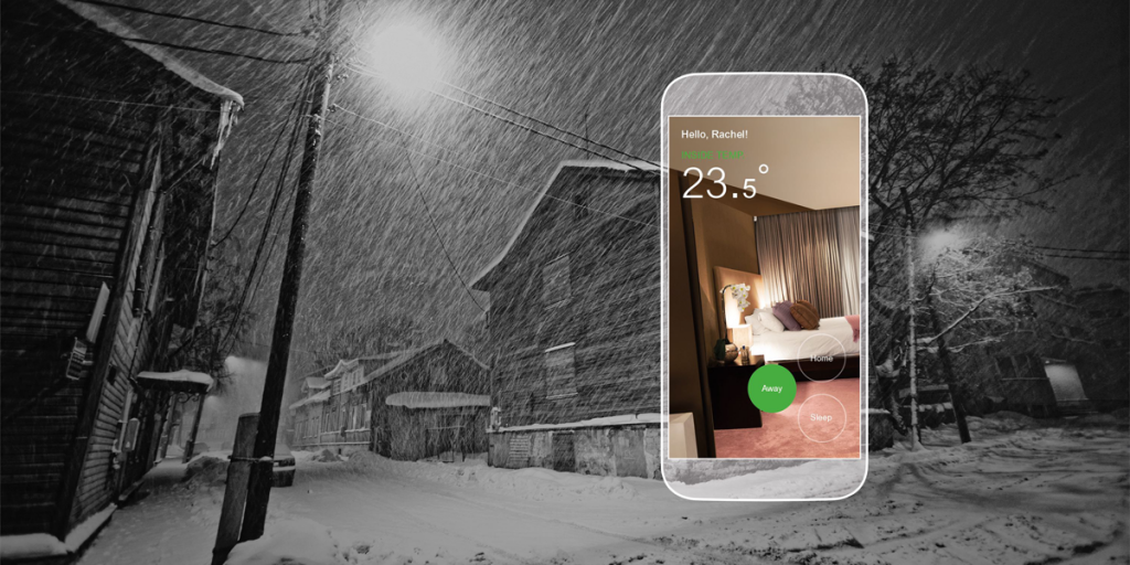 Una calle nevada y un teléfono móvil que marca la temperatura del interior de una habitación.